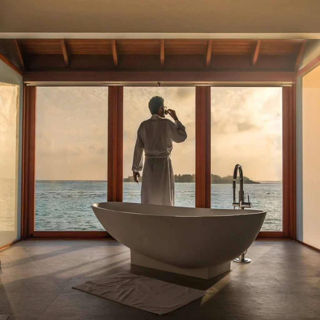 man overlooking the ocean and bathtub